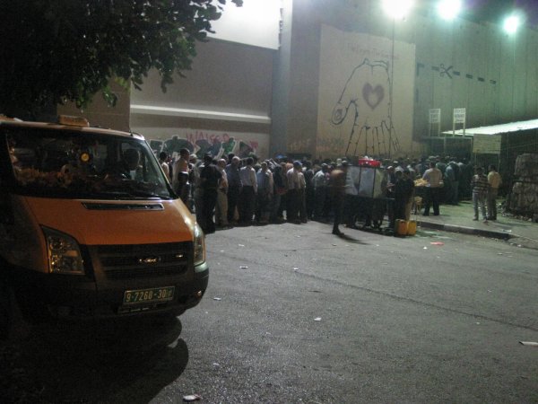 The bottom end of the queue on the Bethlehem side. In front of them are 200-300 other men.......